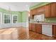 Kitchen with wood cabinets, dishwasher, and hardwood floors at 2720 Lentz Rd, China Grove, NC 28023