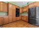 Kitchen boasts wood cabinets, double ovens, and black refrigerator at 2720 Lentz Rd, China Grove, NC 28023