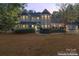 Two story house with wrap around porch, lights on at 2720 Lentz Rd, China Grove, NC 28023