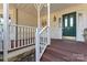 Front entry with green door and white railing at 2720 Lentz Rd, China Grove, NC 28023