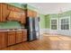 Kitchen offers ample wood cabinetry, a black refrigerator and hardwood floors at 2720 Lentz Rd, China Grove, NC 28023