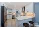 Modern kitchen with white cabinets, quartz countertops, and stainless steel appliances at 810 Woodmoore Ln, Kannapolis, NC 28081