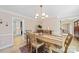 Elegant dining room features a wood table and chandelier, with views to kitchen at 810 Woodmoore Ln, Kannapolis, NC 28081