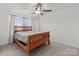 Bright bedroom with ceiling fan and wood bed frame at 1109 Freeman View Dr, Albemarle, NC 28001