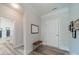 Bright entryway with wood bench, mirror, and view of bathroom at 2014 Newstyle Way, Tega Cay, SC 29708