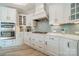 White kitchen with stainless steel appliances and island at 2014 Newstyle Way, Tega Cay, SC 29708