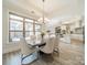 Open concept dining room with kitchen views and large windows at 2014 Newstyle Way, Tega Cay, SC 29708