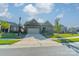 Brick ranch home with attached garage and driveway, on a tree-lined street at 2014 Newstyle Way, Tega Cay, SC 29708