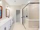 Modern bathroom with double vanity, large mirror, and a glass shower at 216 E Warfield Dr, Mooresville, NC 28115