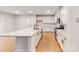 Modern kitchen with white cabinets, stainless steel appliances, and an island at 216 E Warfield Dr, Mooresville, NC 28115