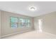 Bright bedroom with three windows, neutral walls, and carpet flooring at 216 E Warfield Dr, Mooresville, NC 28115