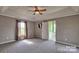 Main bedroom with carpet, ceiling fan, and ensuite bathroom access at 2726 Bluejay Rd, Heath Springs, SC 29058