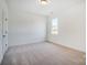 Empty bedroom with neutral carpet and white walls, ready for personalization at 3206 Whispering Creek Dr # 159, Indian Trail, NC 28079