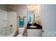 Clean bathroom with dark vanity and shower/tub combo at 139 Saidin Ln, Troutman, NC 28166