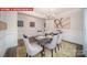 Bright dining room features a modern chandelier and elegant table setting at 131 Saidin Ln, Troutman, NC 28166