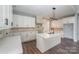 Modern kitchen with white cabinets, large island, and quartz countertops at 1043 Lester Rd, Clover, SC 29710