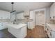 Modern kitchen with white cabinets, large island, and quartz countertops at 1043 Lester Rd, Clover, SC 29710