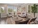 Sunlit living room with sectional sofa, coffee table, and large windows at 3016 Loso Ter # 53, Charlotte, NC 28217