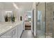 Modern bathroom features double sinks, a shower, and a view into the bedroom at 3016 Loso Ter # 53, Charlotte, NC 28217