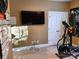 Home gym with elliptical machine and large TV at 5915 Windy Knoll Ln, Mint Hill, NC 28227