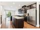 Modern kitchen with granite island, stainless steel appliances, and dark cabinetry at 466 Tremont Ave, Charlotte, NC 28203