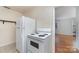 View of kitchen with white appliances and cabinetry at 343 Wakefield Dr # C, Charlotte, NC 28209