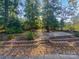 Landscaped backyard with stone retaining wall and patio at 2604 Andes Dr, Statesville, NC 28625