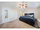 Main bedroom with a king-size bed and carpet flooring at 2038 University Heights Ln, Charlotte, NC 28213