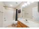 Clean bathroom with tub, shower, and wood vanity at 2038 University Heights Ln, Charlotte, NC 28213