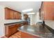 Spacious kitchen with dark wood cabinets and granite countertops at 1994 Quill Ct, Kannapolis, NC 28083