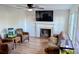 Living room with fireplace, hardwood floors, and two leather armchairs at 2292 Shiloh Unity Rd, Lancaster, SC 29720