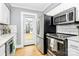 Modern kitchen with white cabinets, stainless steel appliances and marble countertops at 275 S Church St, Mooresville, NC 28115