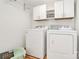 Bright laundry room with washer, dryer, and upper cabinets at 275 S Church St, Mooresville, NC 28115