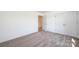 Spacious bedroom with neutral carpeting and access to another room at 414 Drumstand Rd, Stony Point, NC 28678