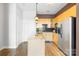 Modern kitchen with light wood cabinets, granite counters, and stainless steel appliances at 706 N Davidson St, Charlotte, NC 28202