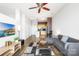Open living room with hardwood floors, L-shaped sofa, and kitchen with island at 706 N Davidson St, Charlotte, NC 28202