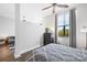 Bedroom with window, dresser, and queen bed, view into living area at 706 N Davidson St, Charlotte, NC 28202