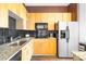 Modern kitchen with light wood cabinets, granite counters, and stainless steel appliances at 706 N Davidson St, Charlotte, NC 28202