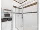 Bathroom with shower, tiled walls, and storage at 706 N Davidson St, Charlotte, NC 28202