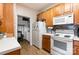 Kitchen with white appliances and laundry access at 11264 Hyde Pointe Ct, Charlotte, NC 28262