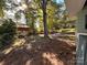 Large backyard with mature trees and swing set at 704 Mcadenville Rd, Lowell, NC 28098