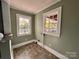 Bright laundry room with tile floor and two windows at 704 Mcadenville Rd, Lowell, NC 28098