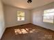 Spacious bedroom with carpet and large window at 704 Mcadenville Rd, Lowell, NC 28098