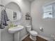 Small bathroom with pedestal sink and toilet at 210 Audra Faye Ln, Indian Trail, NC 28079