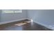 Well-lit bedroom featuring hardwood floors and a corner view at 5323 Buena Vista Ave, Charlotte, NC 28205