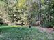 Wooded backyard with grill and fire pit at 8701 Karibuni Dr, Waxhaw, NC 28173