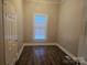 Simple bedroom with hardwood floors and a window at 508 S Yadkin Ave, Spencer, NC 28159