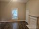 Bright bedroom with hardwood floors and a fireplace at 508 S Yadkin Ave, Spencer, NC 28159