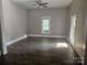 Spacious living room with hardwood floors and large window at 508 S Yadkin Ave, Spencer, NC 28159