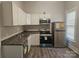 Modern kitchen with stainless steel appliances and white cabinets at 508 S Yadkin Ave, Spencer, NC 28159